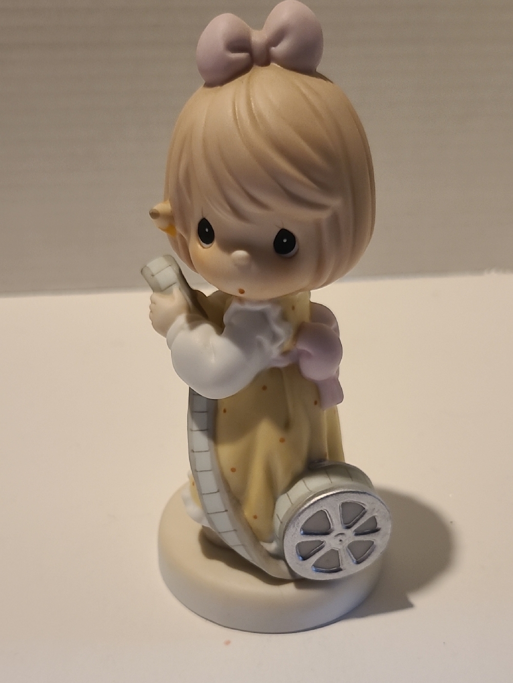 Precious Moments Pastel Girl Figurine With Movie Reel - 1999 Event Figurine